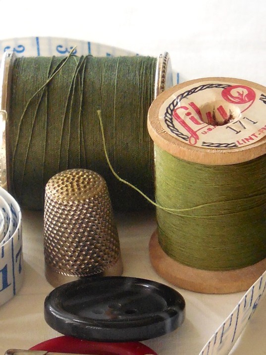 Thread, thimble, button.