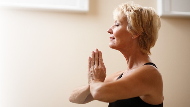 woman sits in yoga pose.