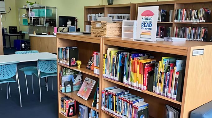 Bookshelves and table with front desk.