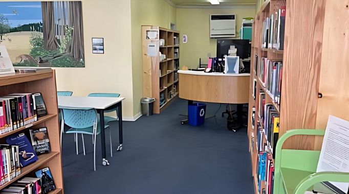 Bookshelves and table with front desk.